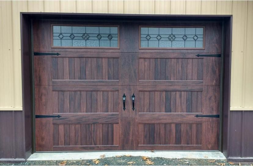 Brown garage door with decorative glass panes and hardware.