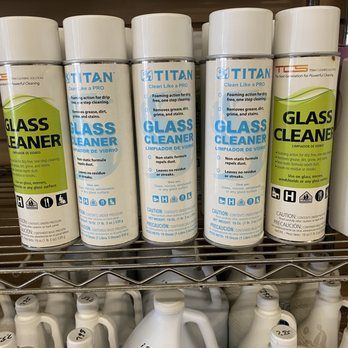 A shelf filled with bottles of glass cleaner.
