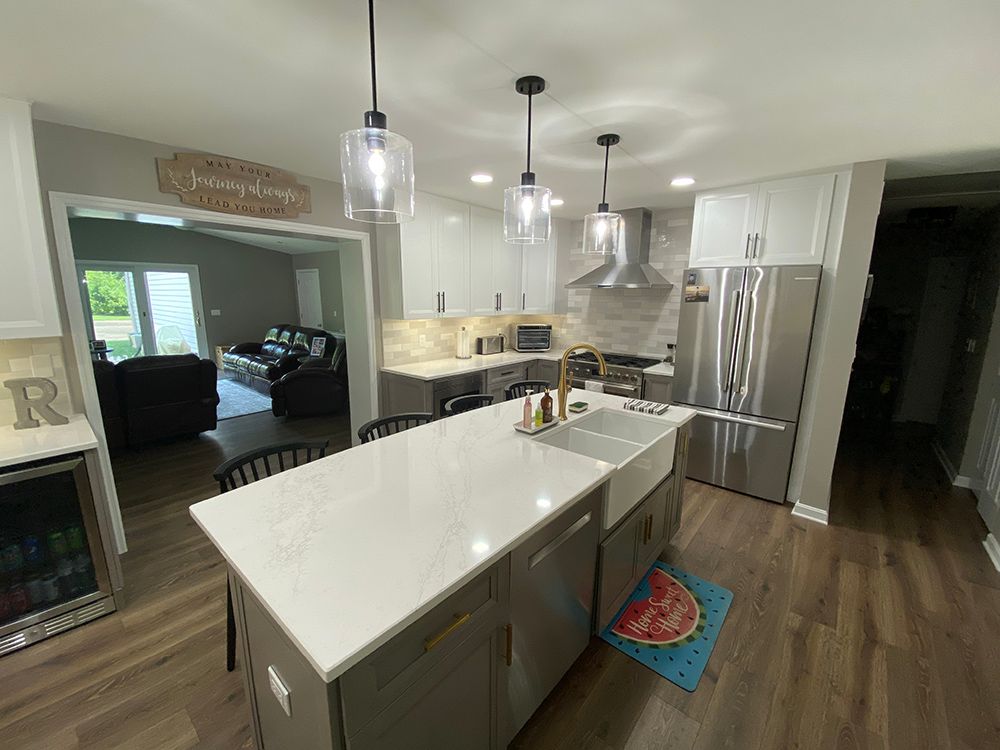 A kitchen with a large island and stainless steel appliances