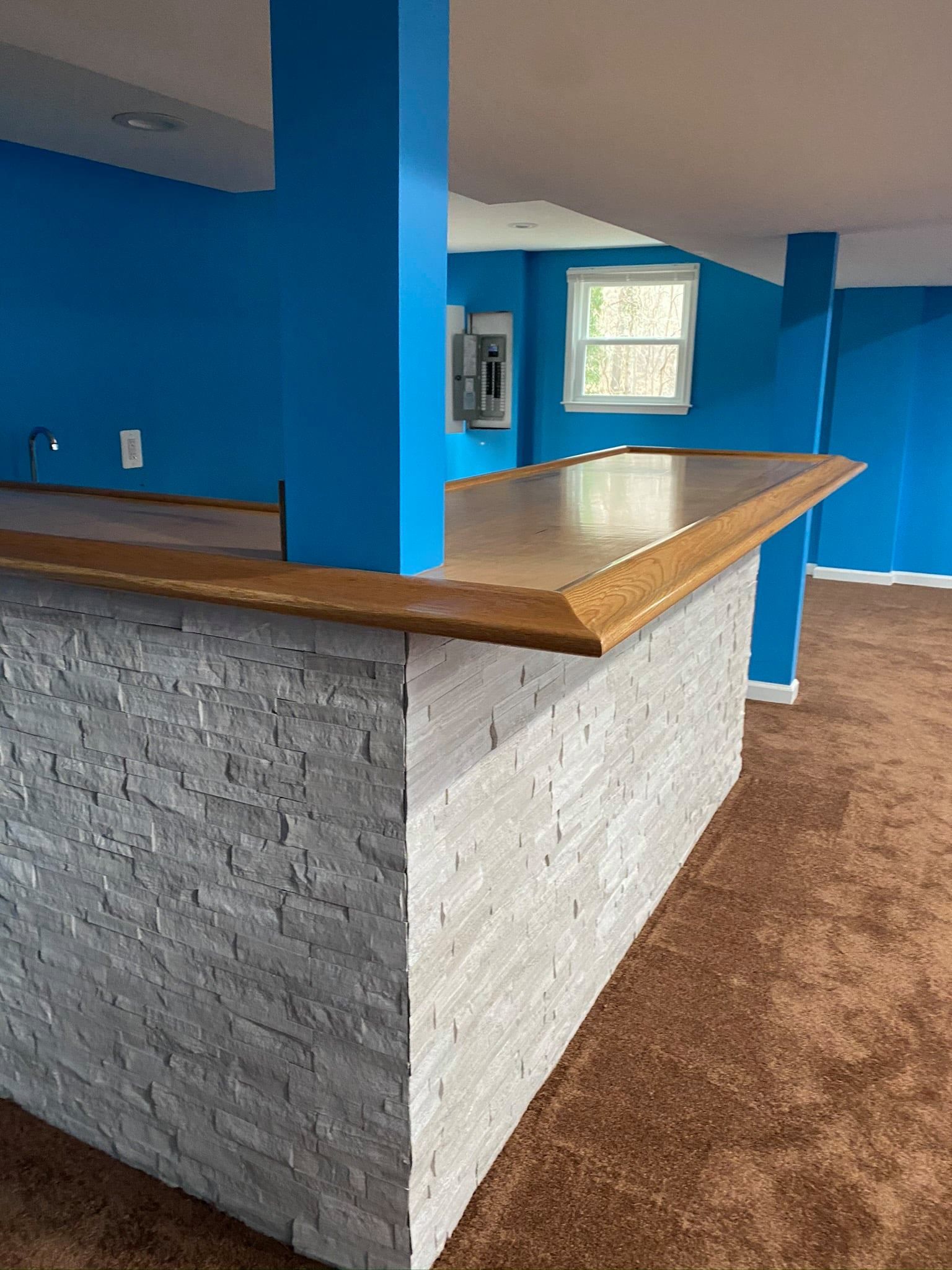 A kitchen with blue walls and a wooden counter top.