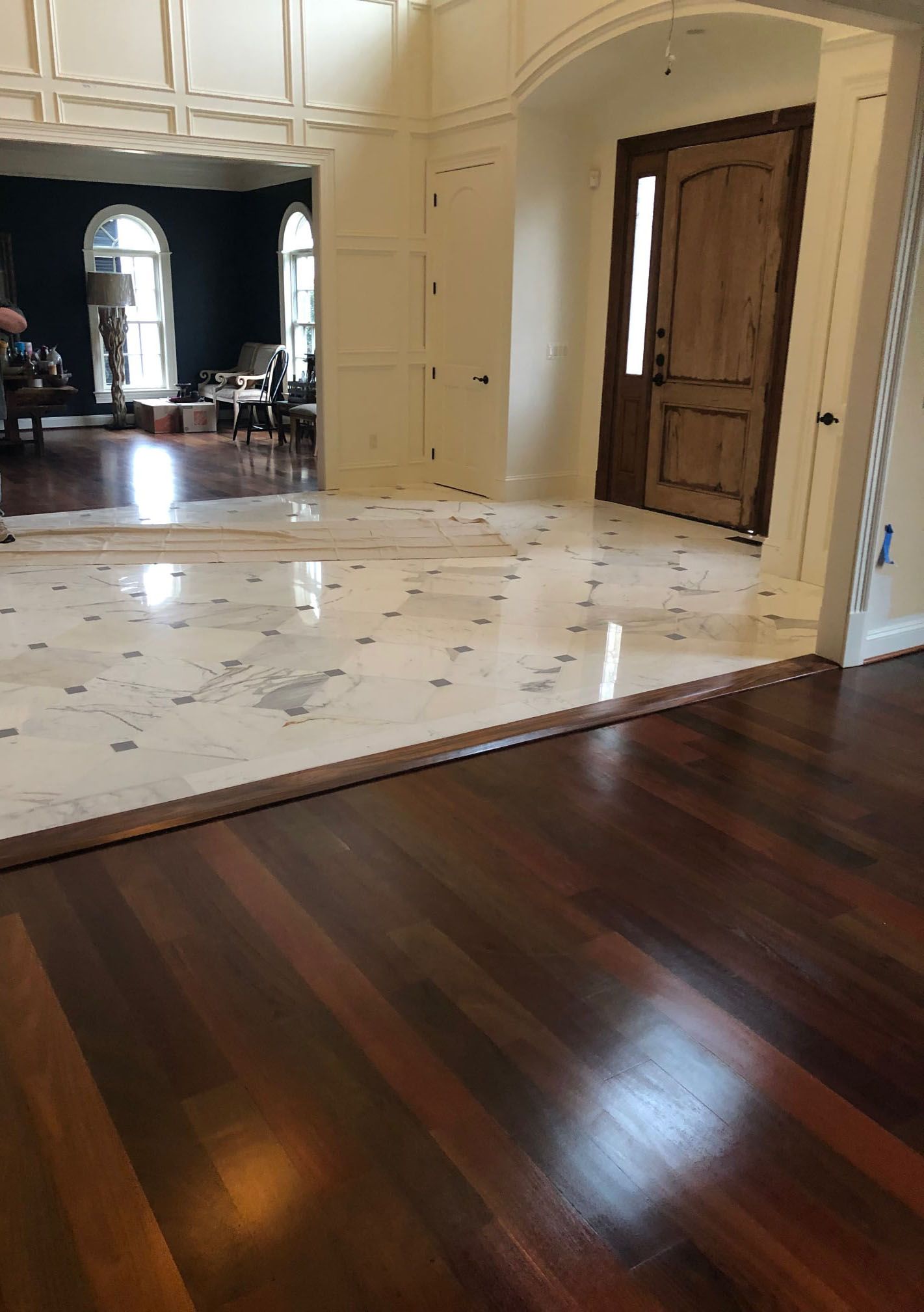 A living room with hardwood floors and a marble floor.