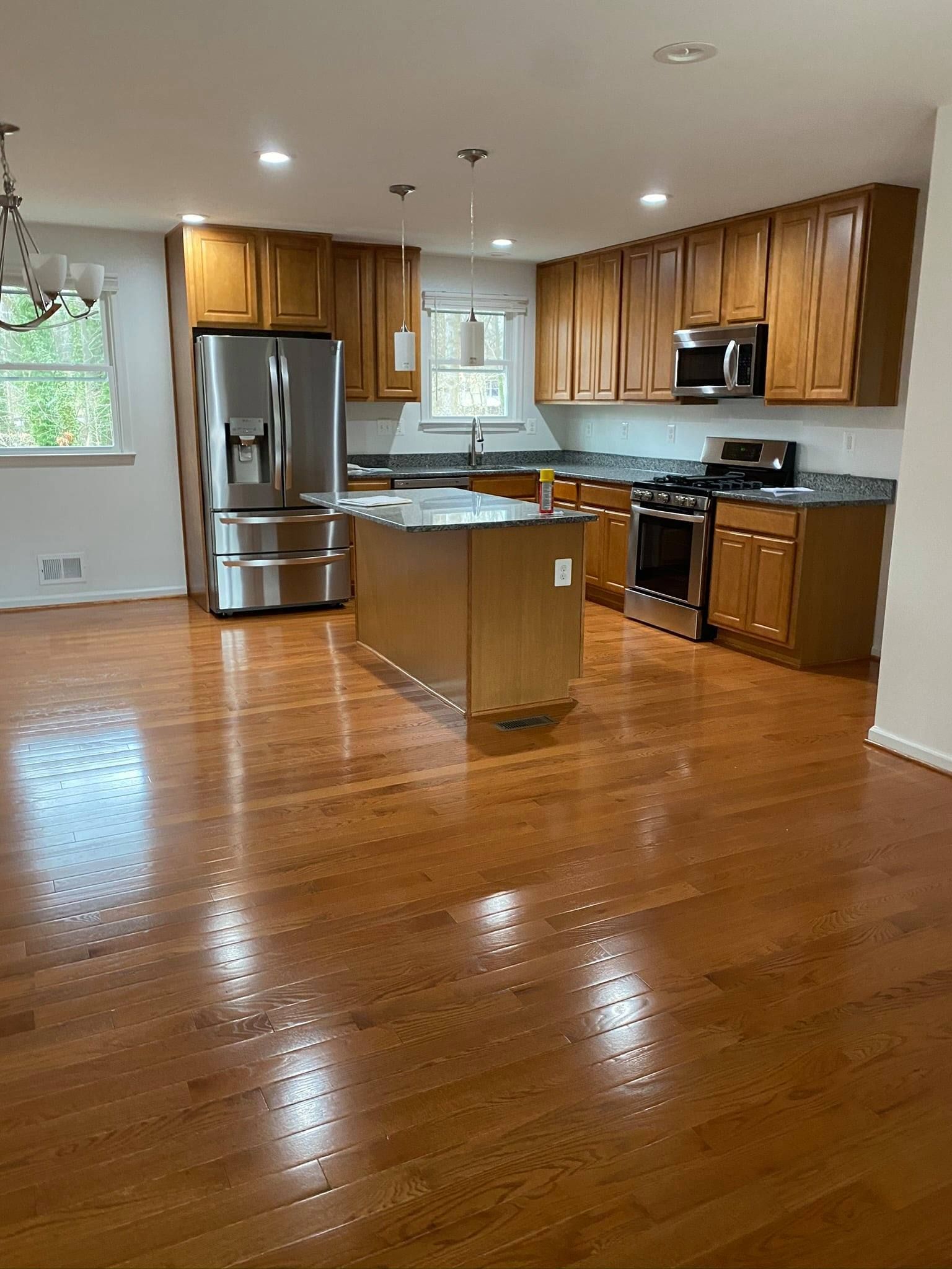 A kitchen with wooden cabinets and stainless steel appliances.