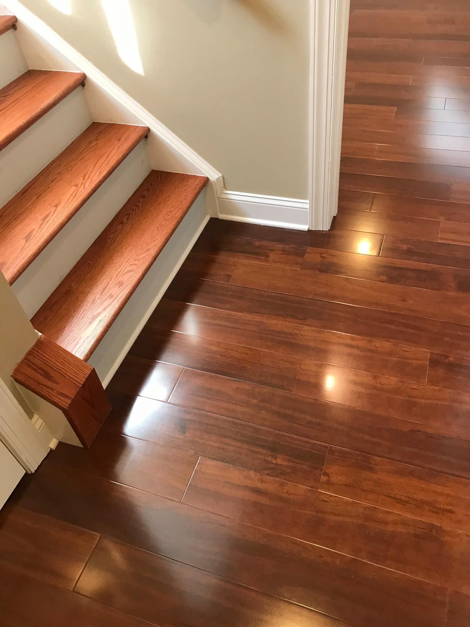 A staircase with wooden steps and a wooden floor in a house.