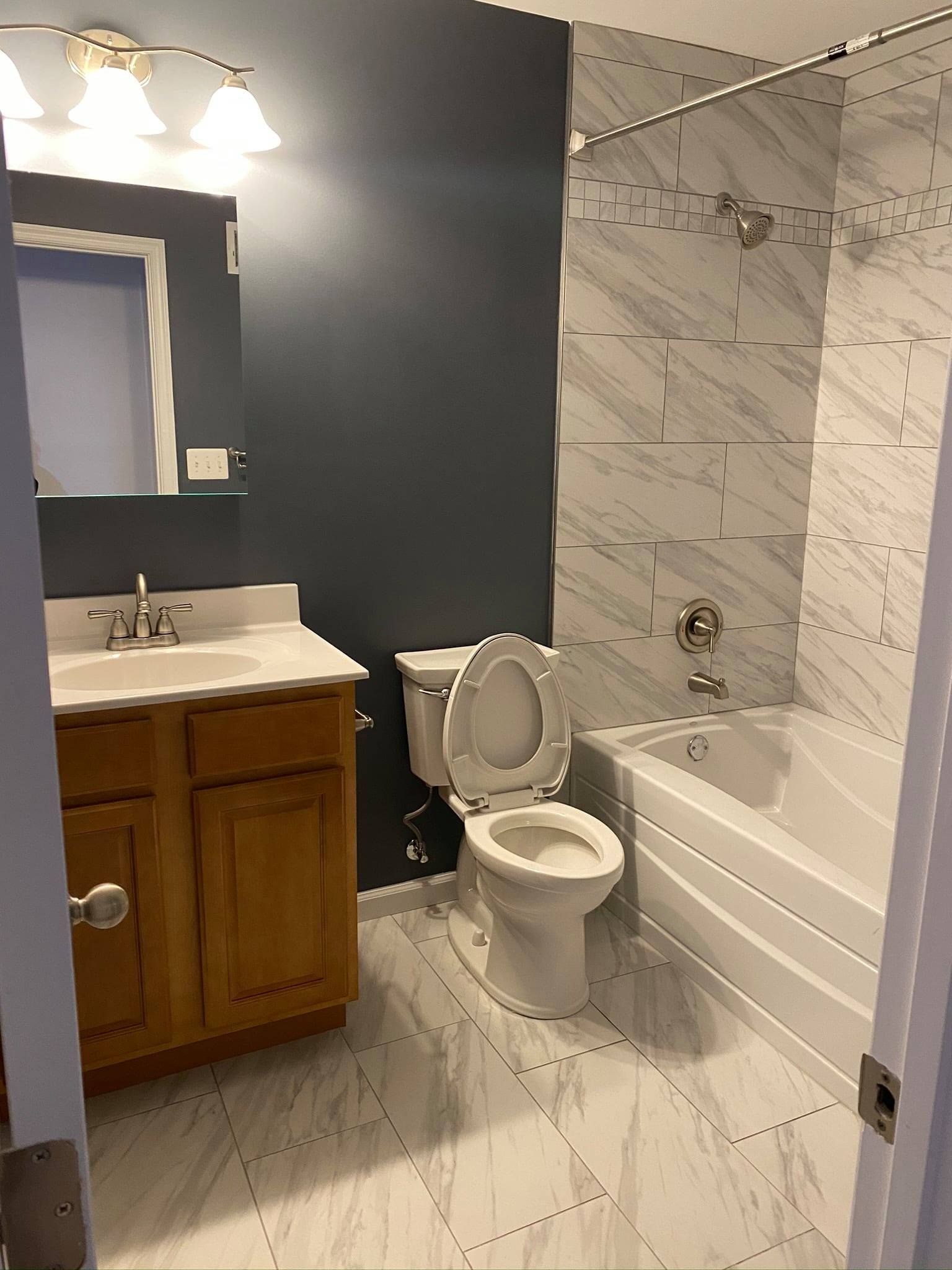 A bathroom with a toilet, sink, and bathtub.