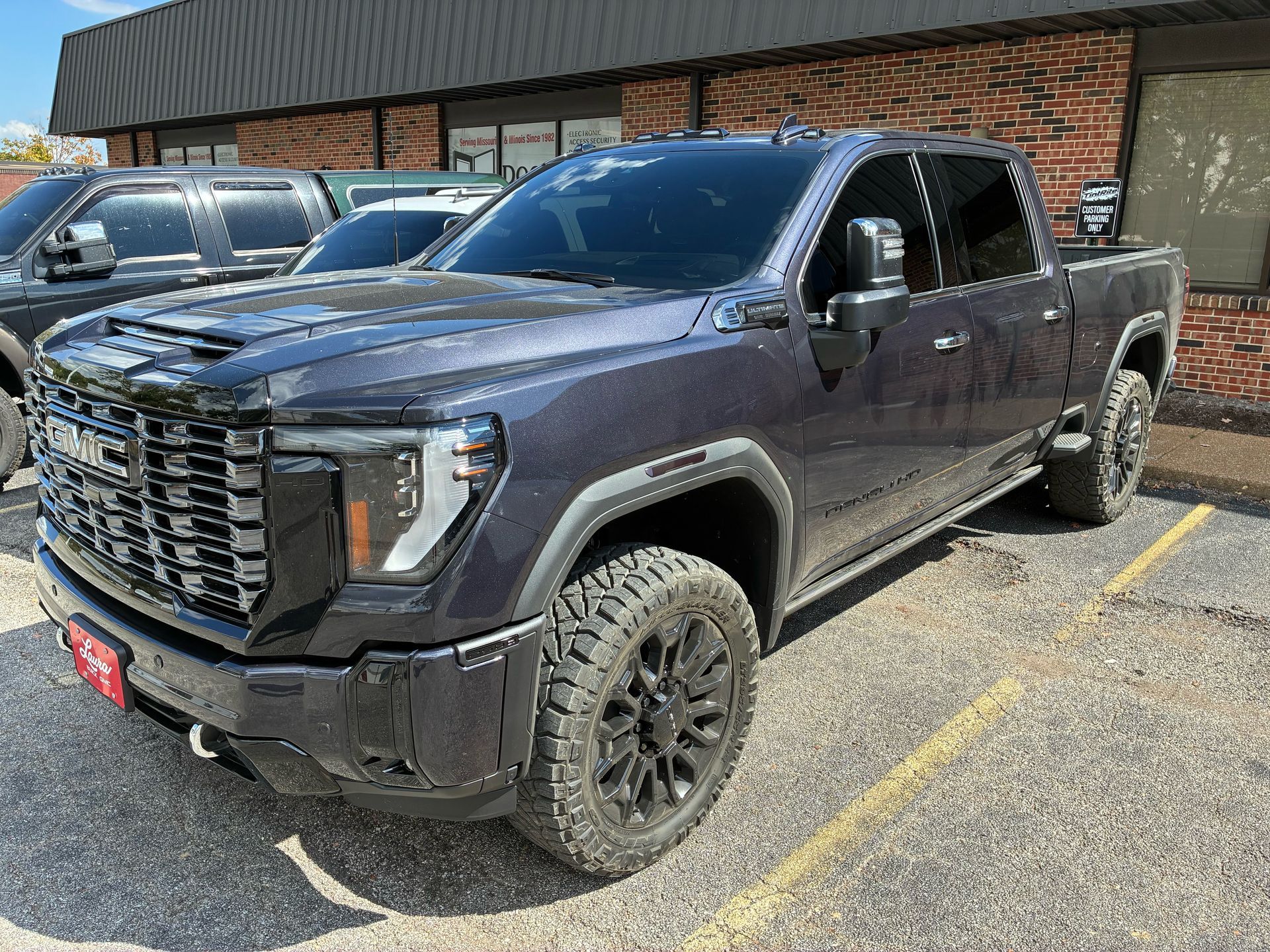 Dark gray GMC Sierra truck parked outside a building.