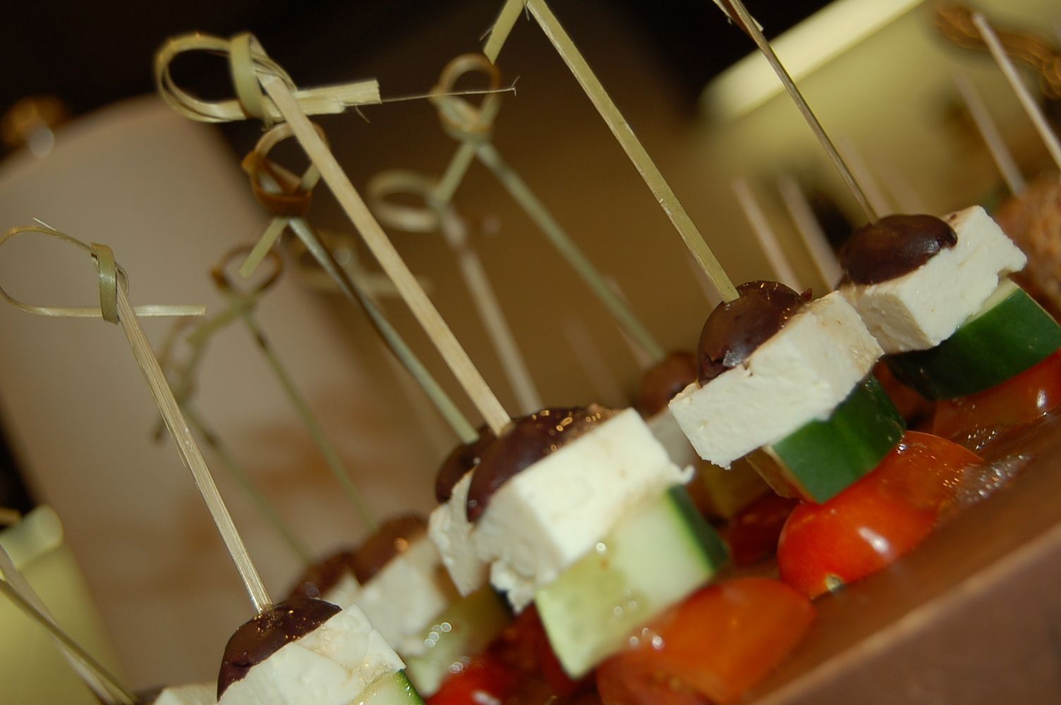 A close up of food on skewers on a table