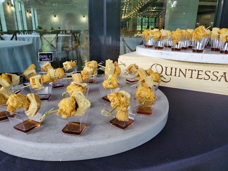 A tray of food on a table next to a box that says quintessa