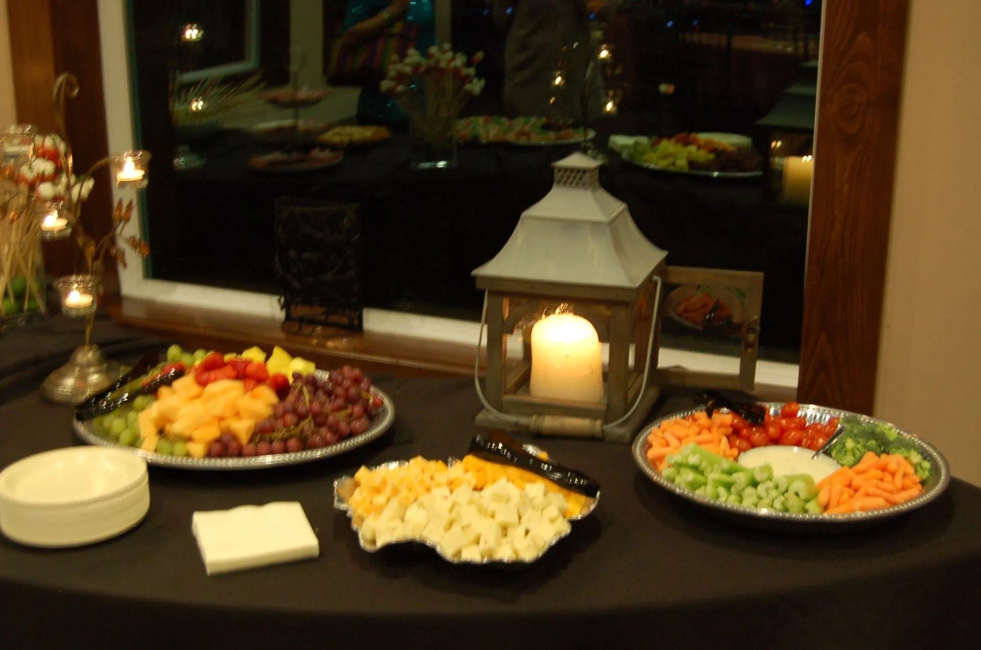 A table with plates of food and a candle on it