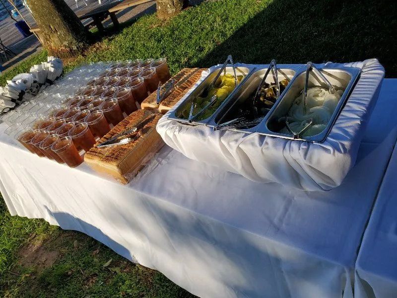 A table with a variety of food and drinks on it.
