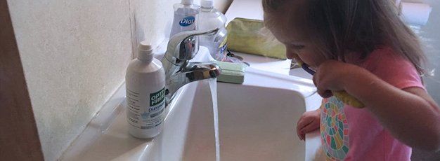 Child brushing her teeth