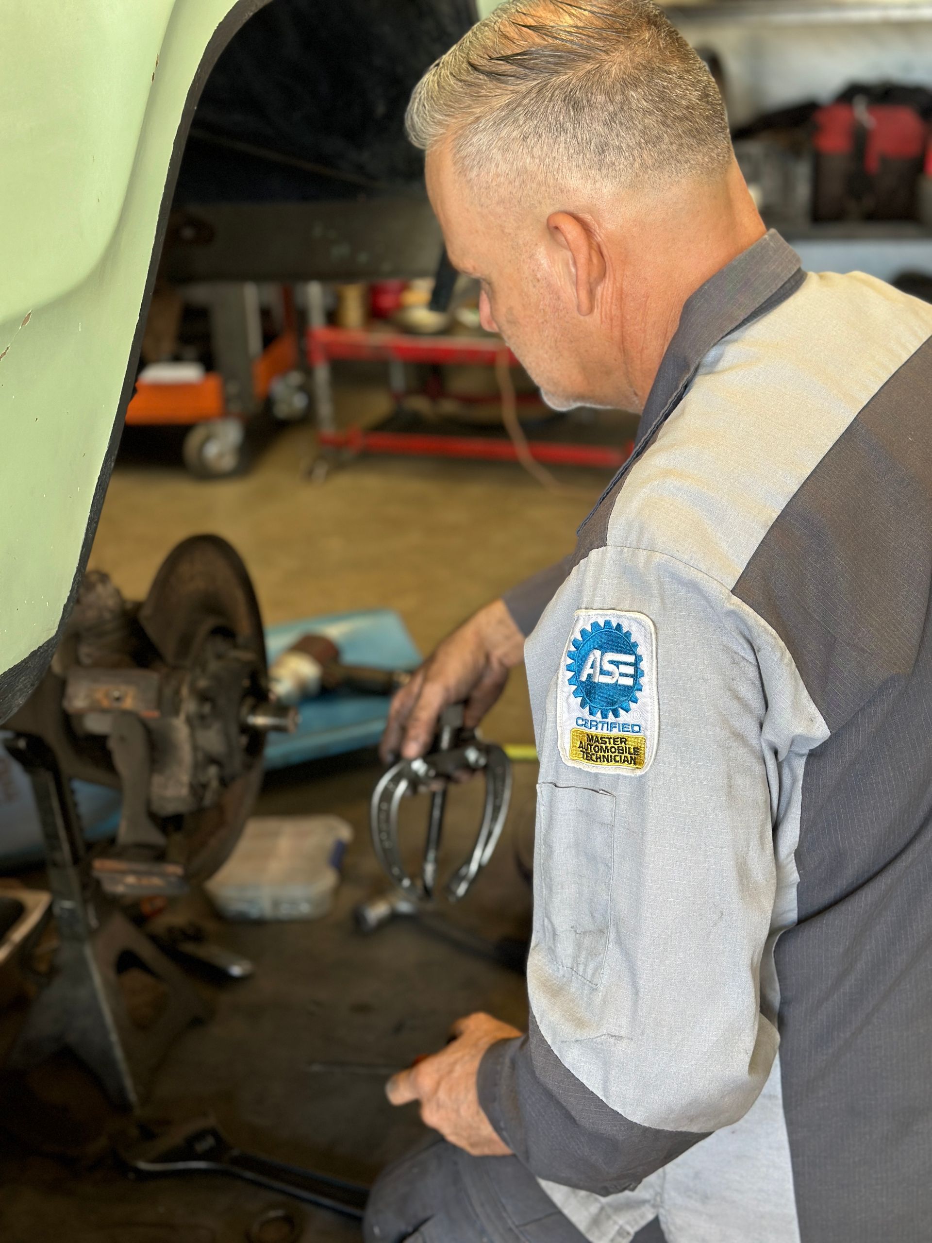 A man is working on a car in a garage