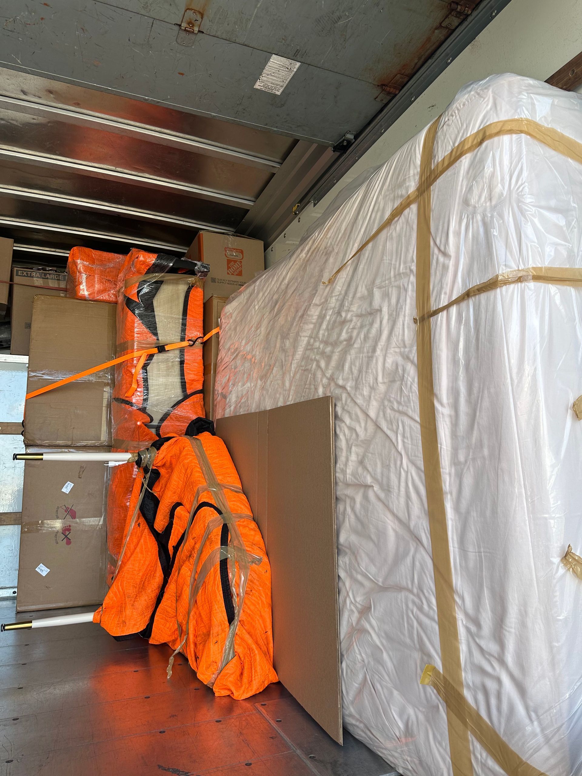 A mattress is sitting in the back of a moving truck