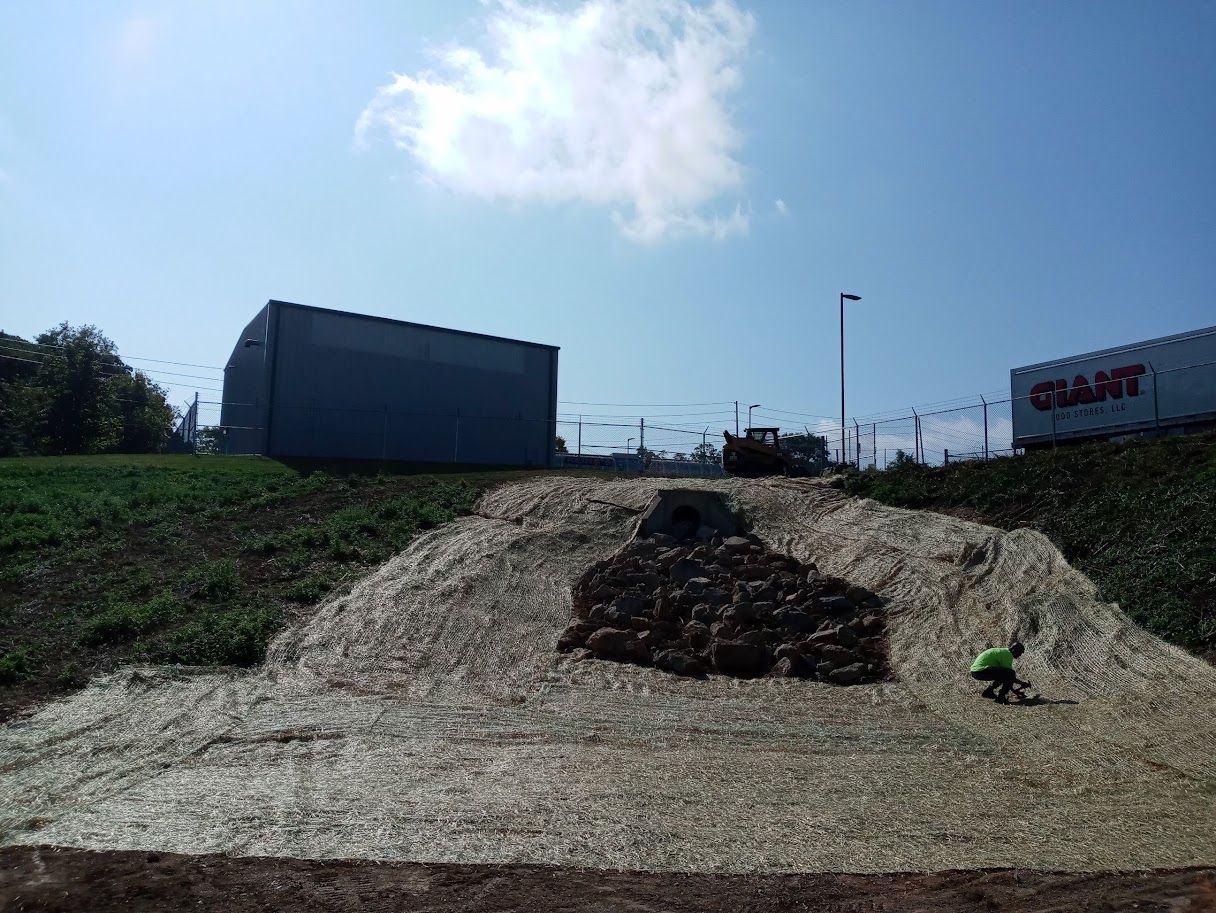 A large pile of dirt is sitting in front of a building that says giant.