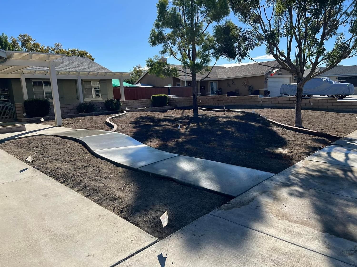 a concrete walkway is being built in front of a house