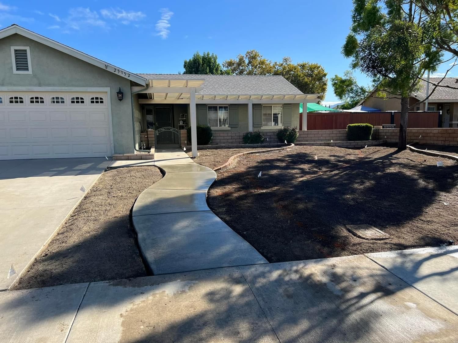 a house with a concrete walkway leading to it