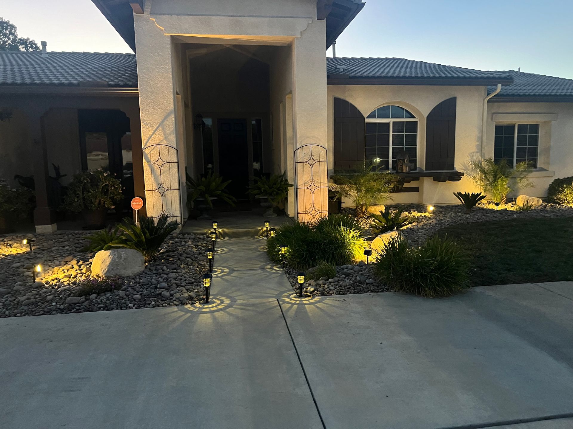 the front of a house is lit up at night