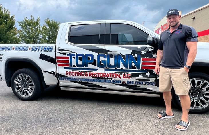 Man standing by a white truck with 
