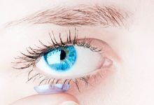 blue eye and a contact lense infront
