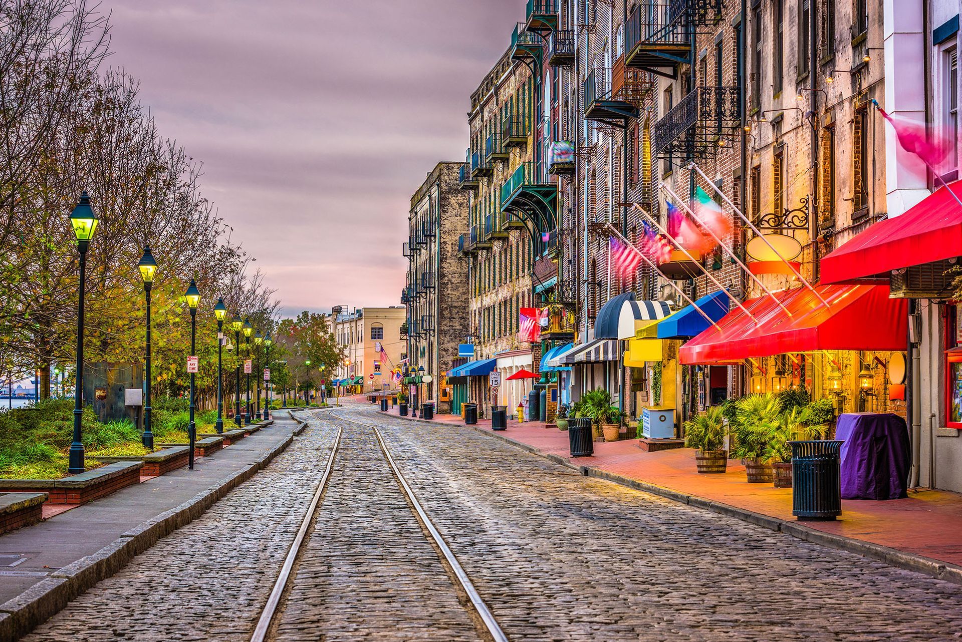 A cobblestone street with train tracks going down it.