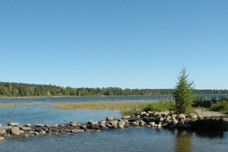 A large body of water surrounded by trees and rocks