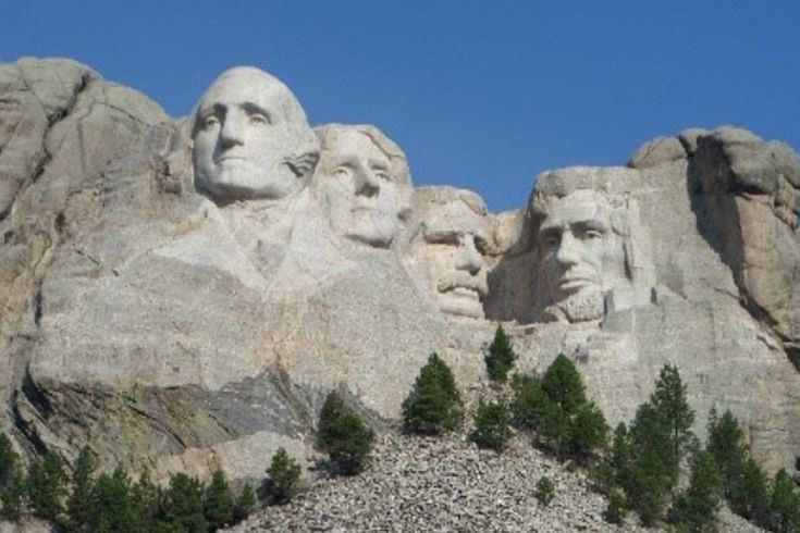 A mountain with a statue of four presidents on it