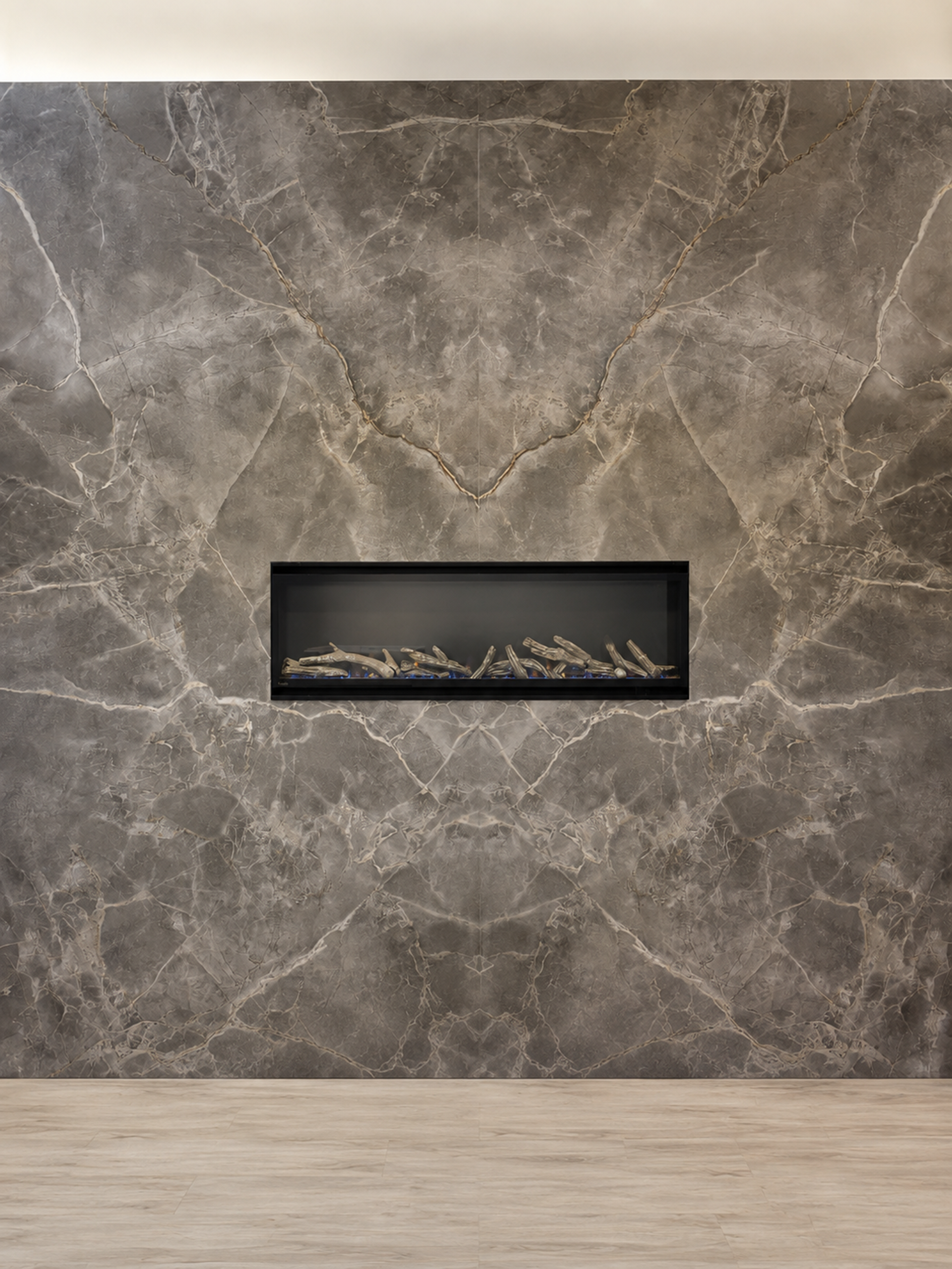 Modern stone fireplace wall with a narrow rectangular fire opening and light wood floor
