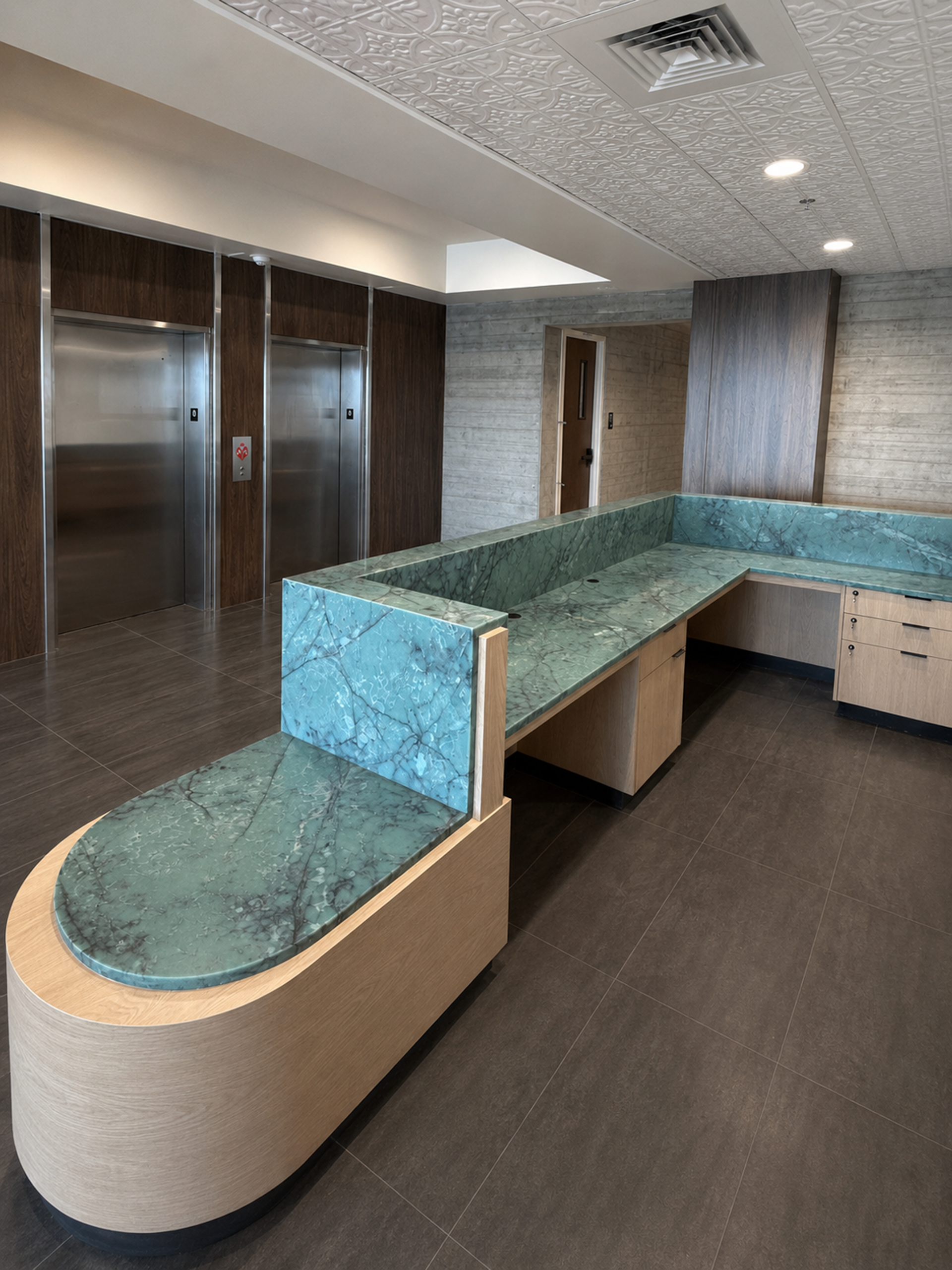 Modern office lobby with turquoise reception desk and wood-paneled walls