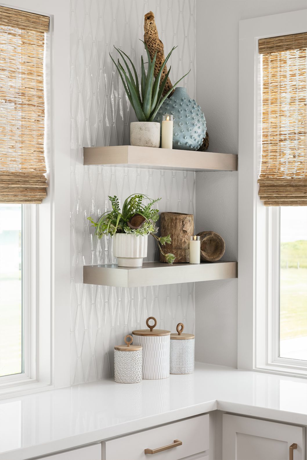 Corner shelves with woven baskets, potted plants, and decor between two window blinds in a bright room