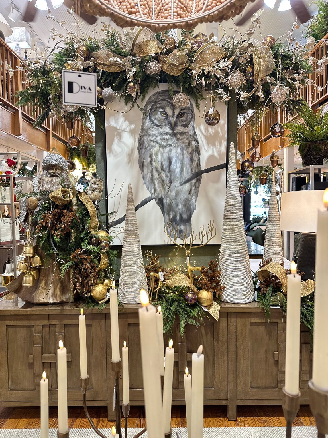 Festive altar with candles, floral garlands, and a large owl portrait in a decorated indoor hall