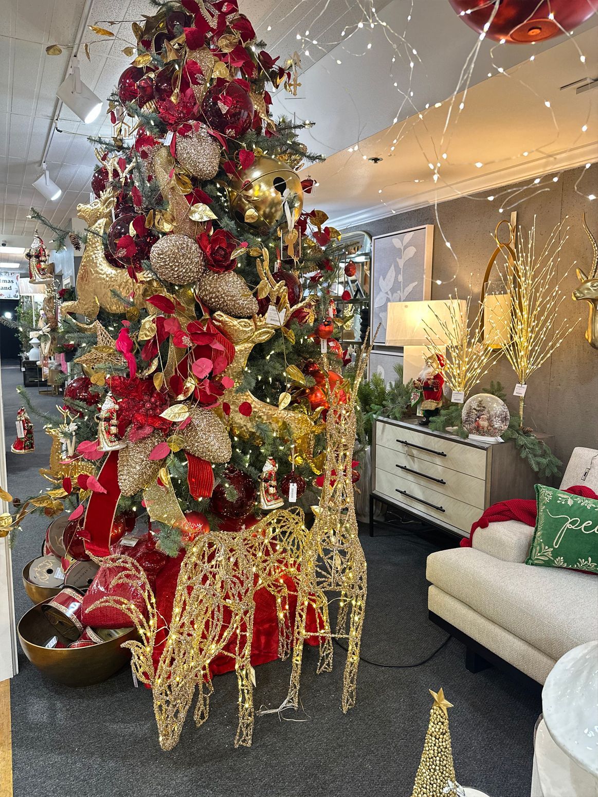 Decorated Christmas tree with gold reindeer ornaments in a modern living room