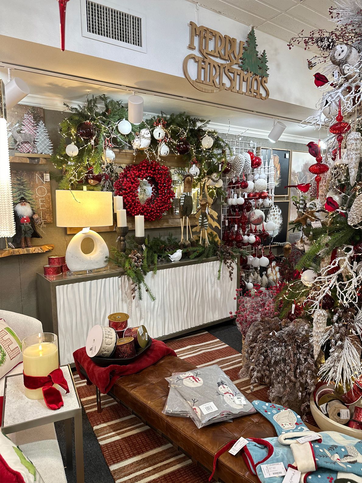 Festive living room with Christmas decorations, wreaths, ornaments, and a decorated tree