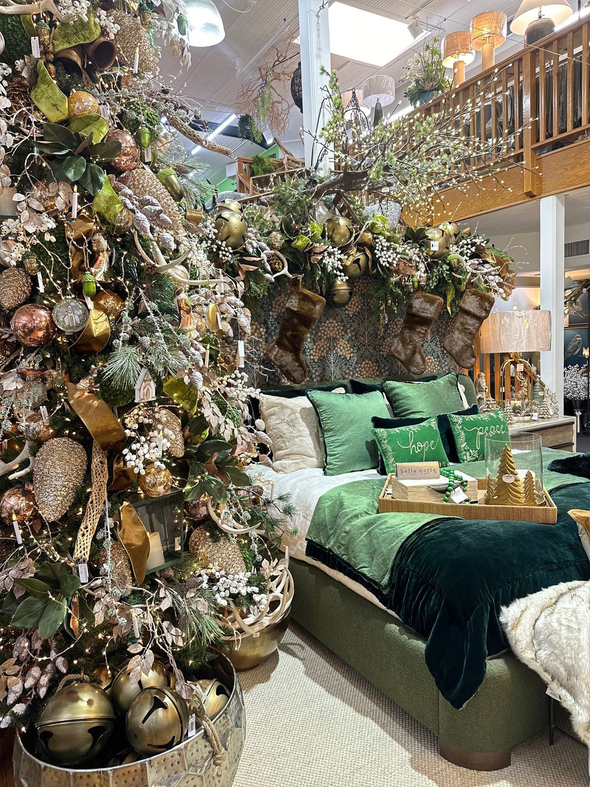 Festive bedroom with a decorated tree, green bedding, and sparkling holiday decor