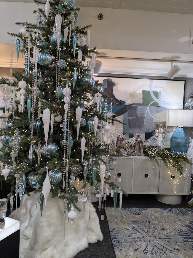 Decorated Christmas tree with silver and white ornaments in a stylish living room