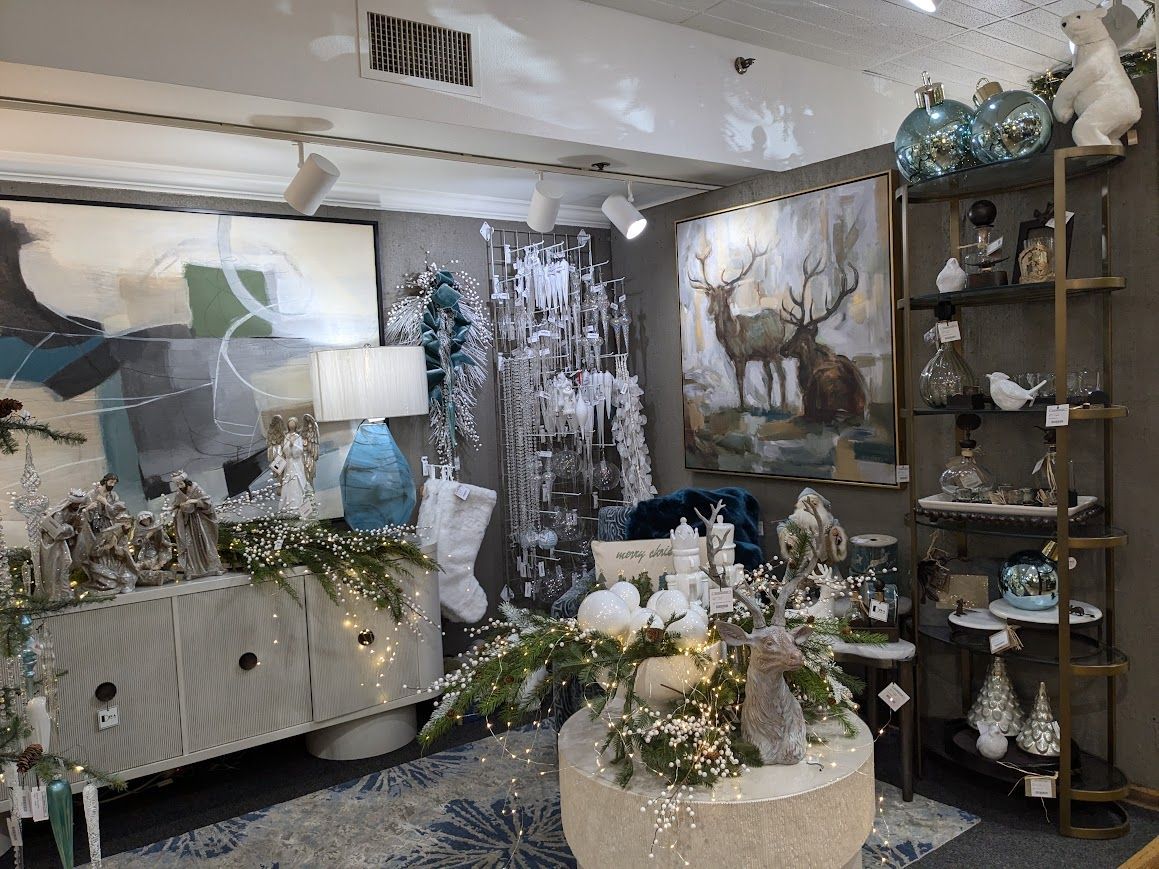 Elegant flower-filled boutique interior with white displays, abstract art, and decorative shelves