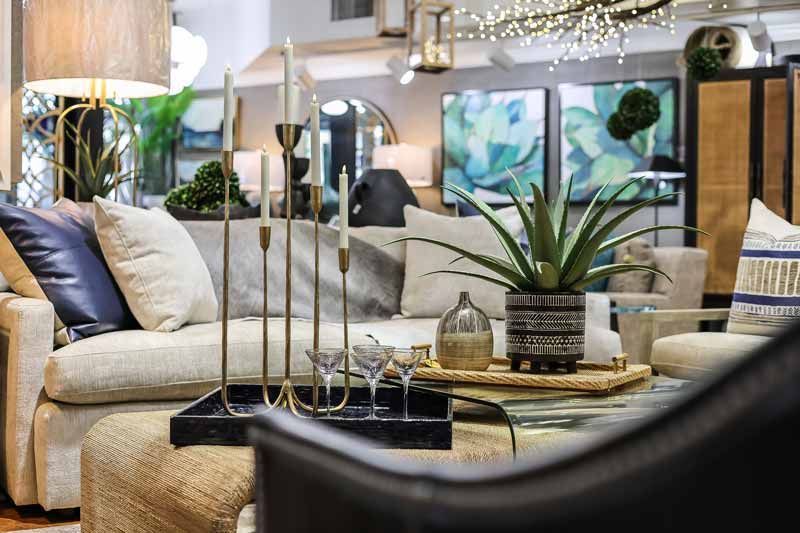 Stylish living room with beige sofas, decorative pillows, a coffee table, and modern art accents