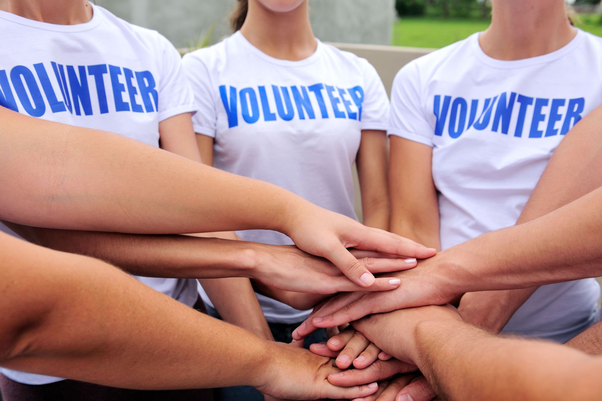 Volunteers in matching white shirts with blue