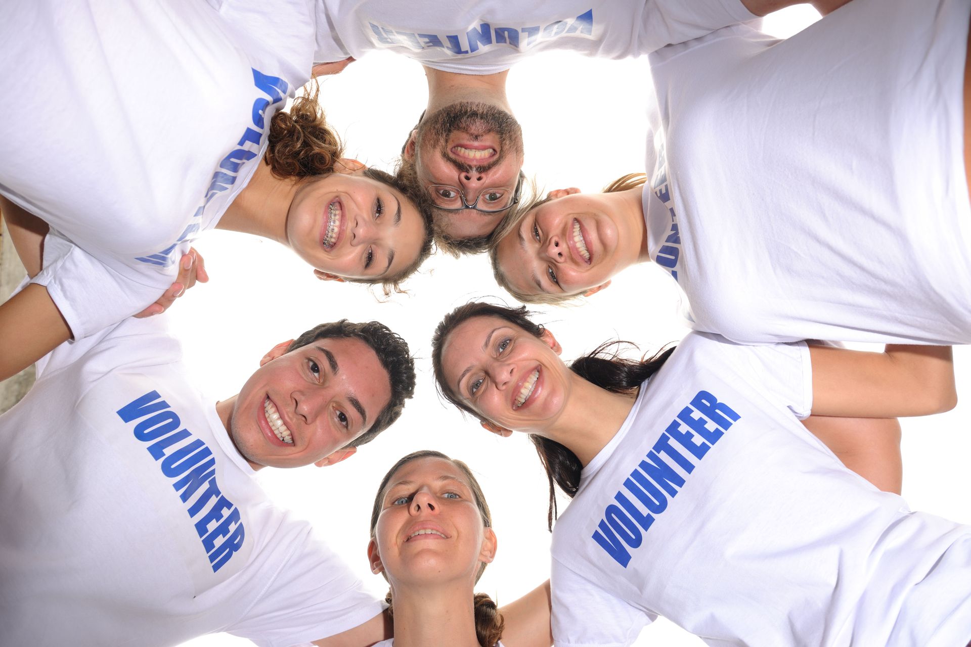 Group of volunteers in white shirts with