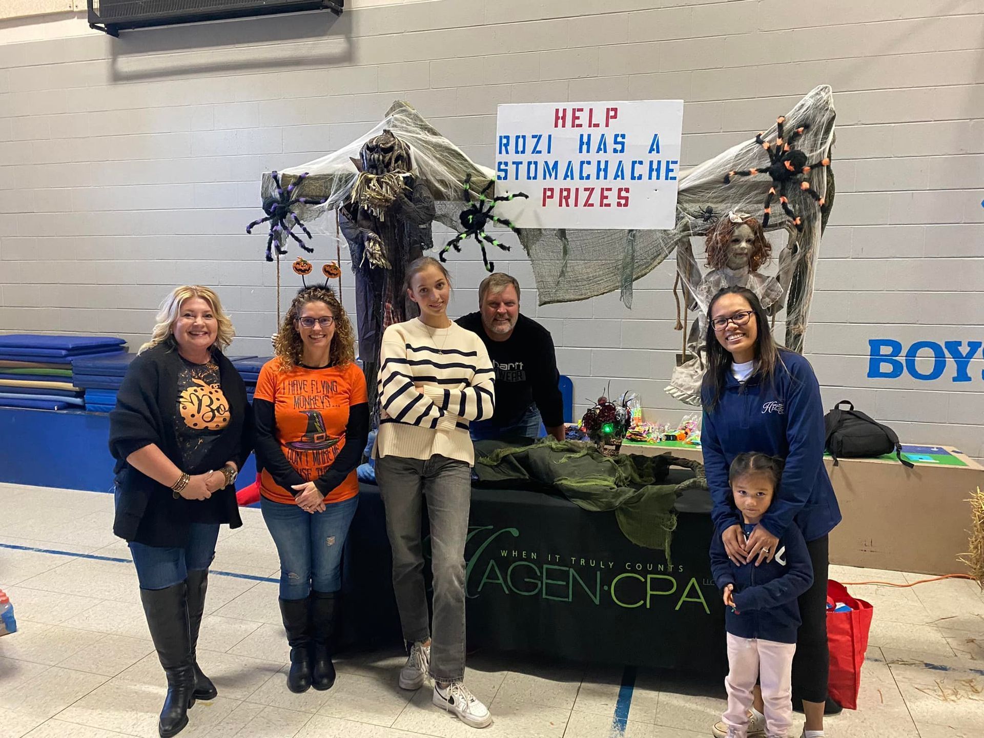 Group at a decorated booth, sign says