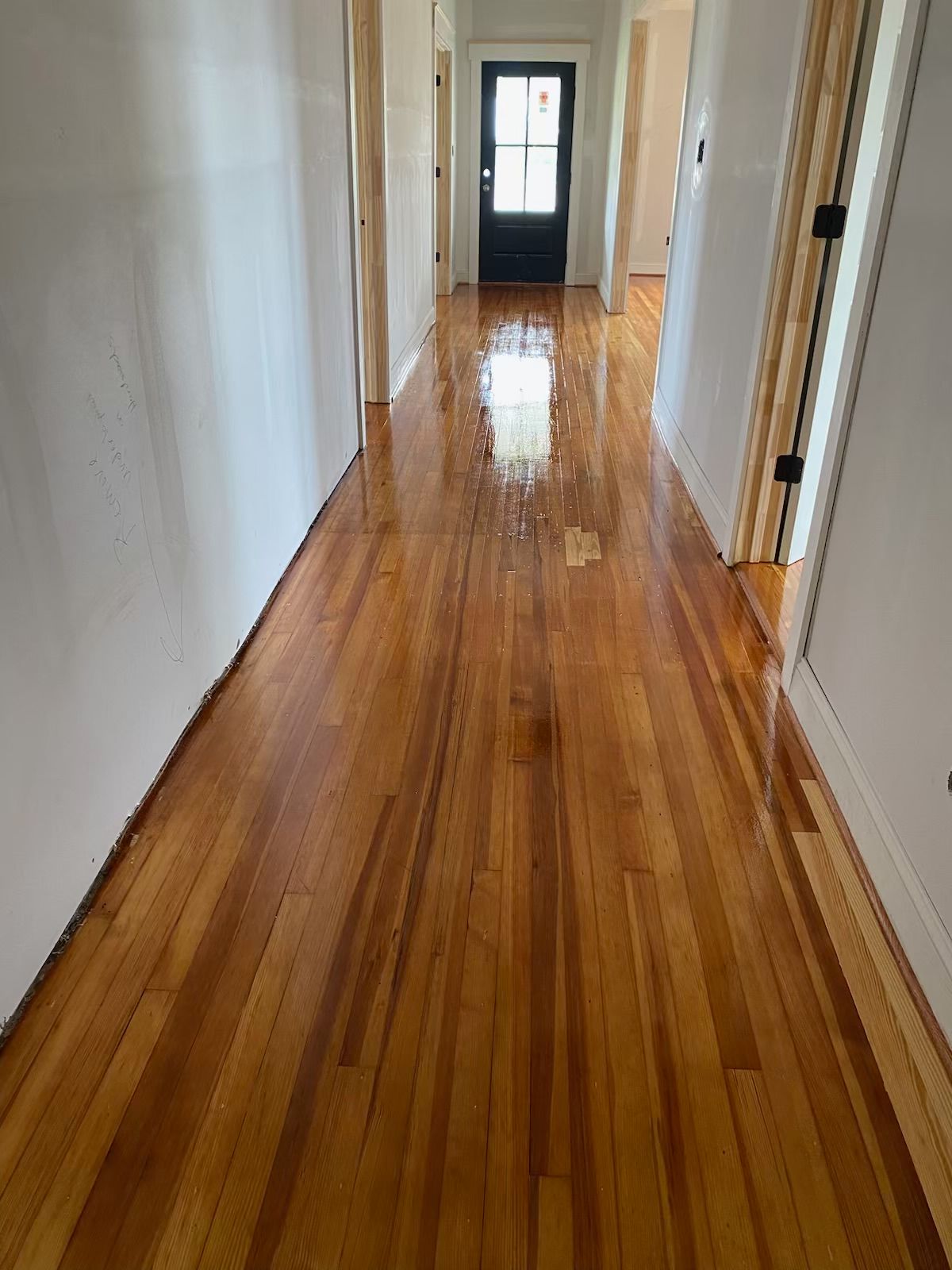 A long hallway with hardwood floors