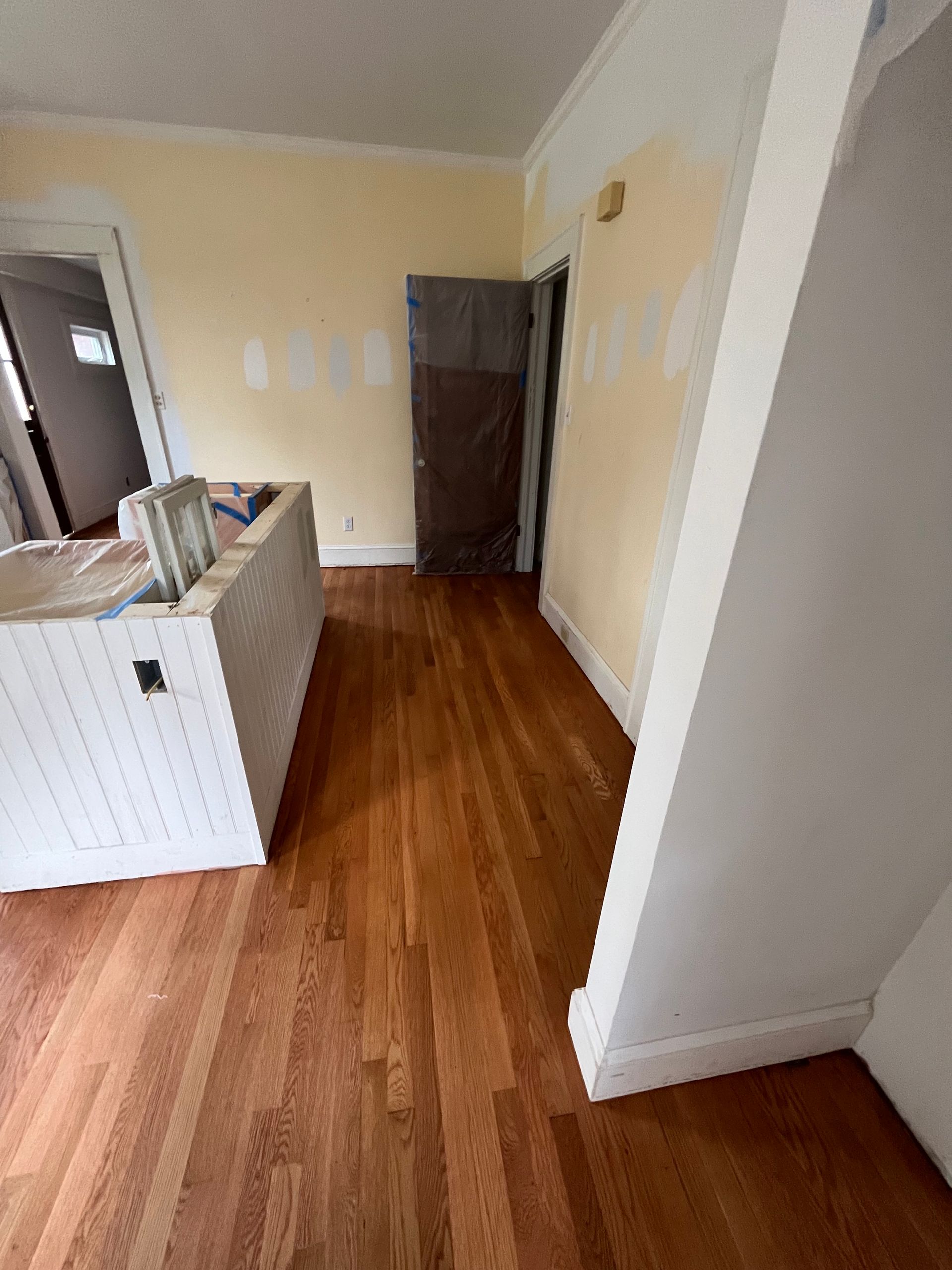 A living room with hardwood floors and white walls.