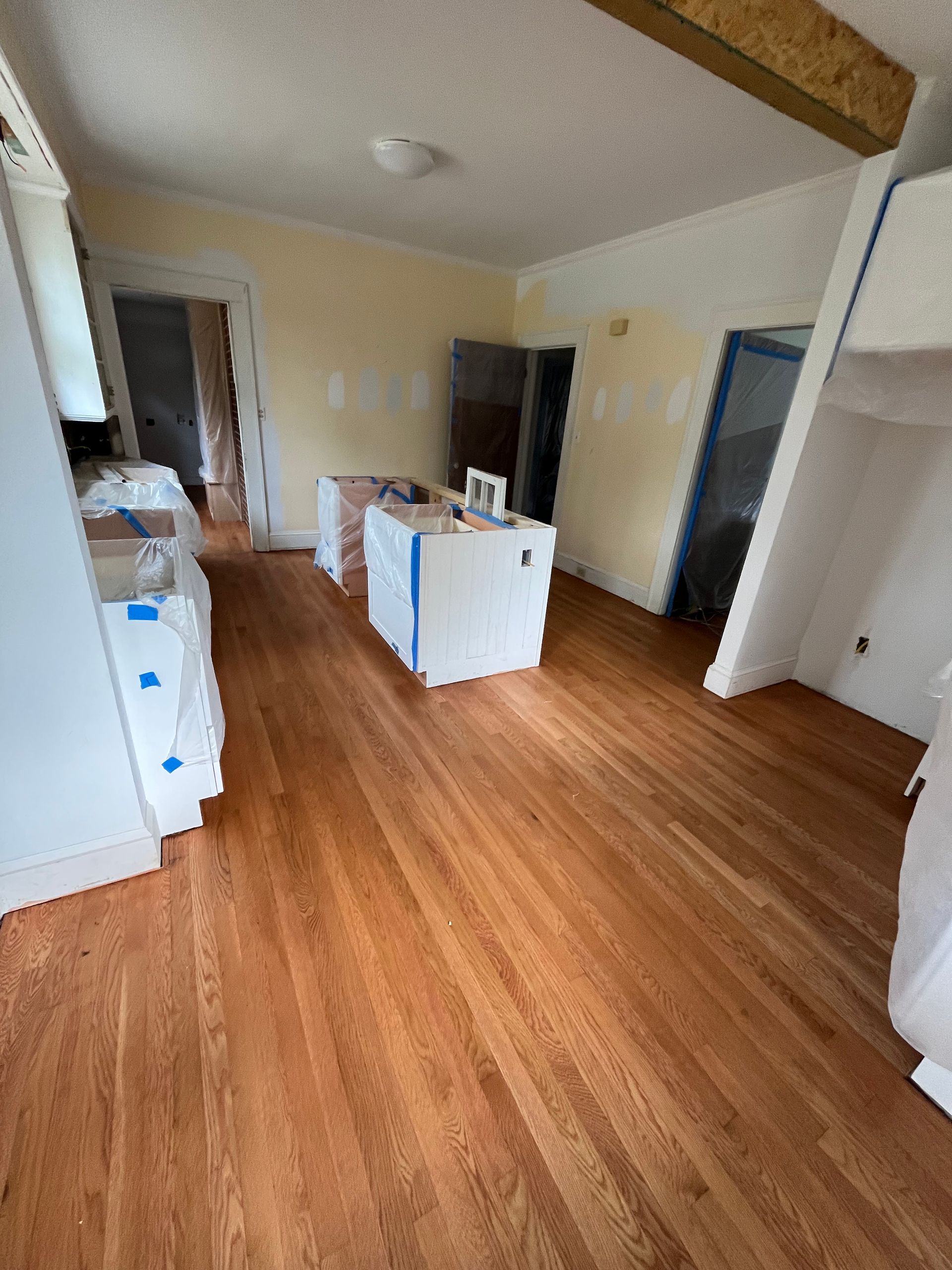 A living room with hardwood floors and white walls.
