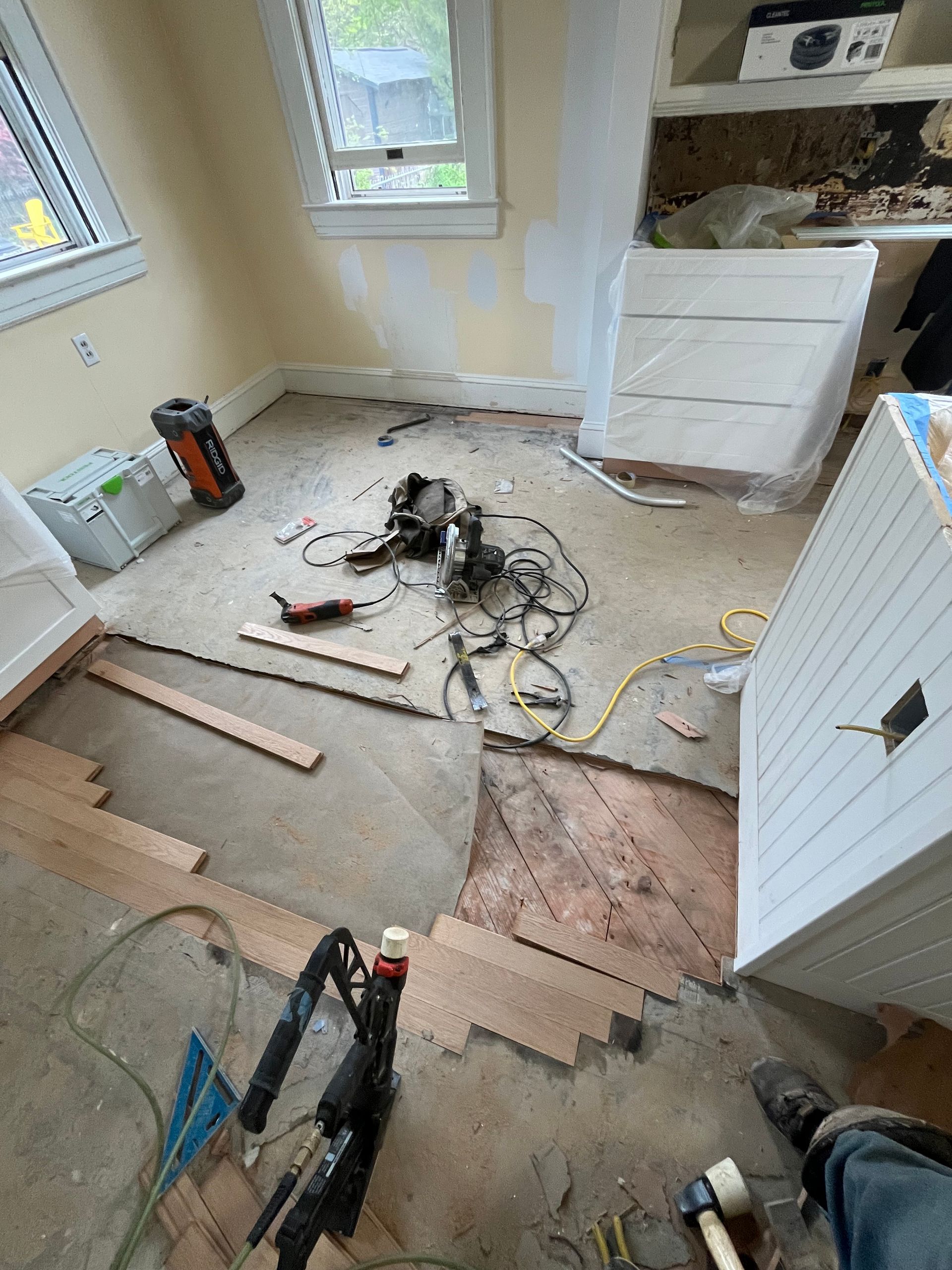 A room with a lot of tools on the floor and a window.