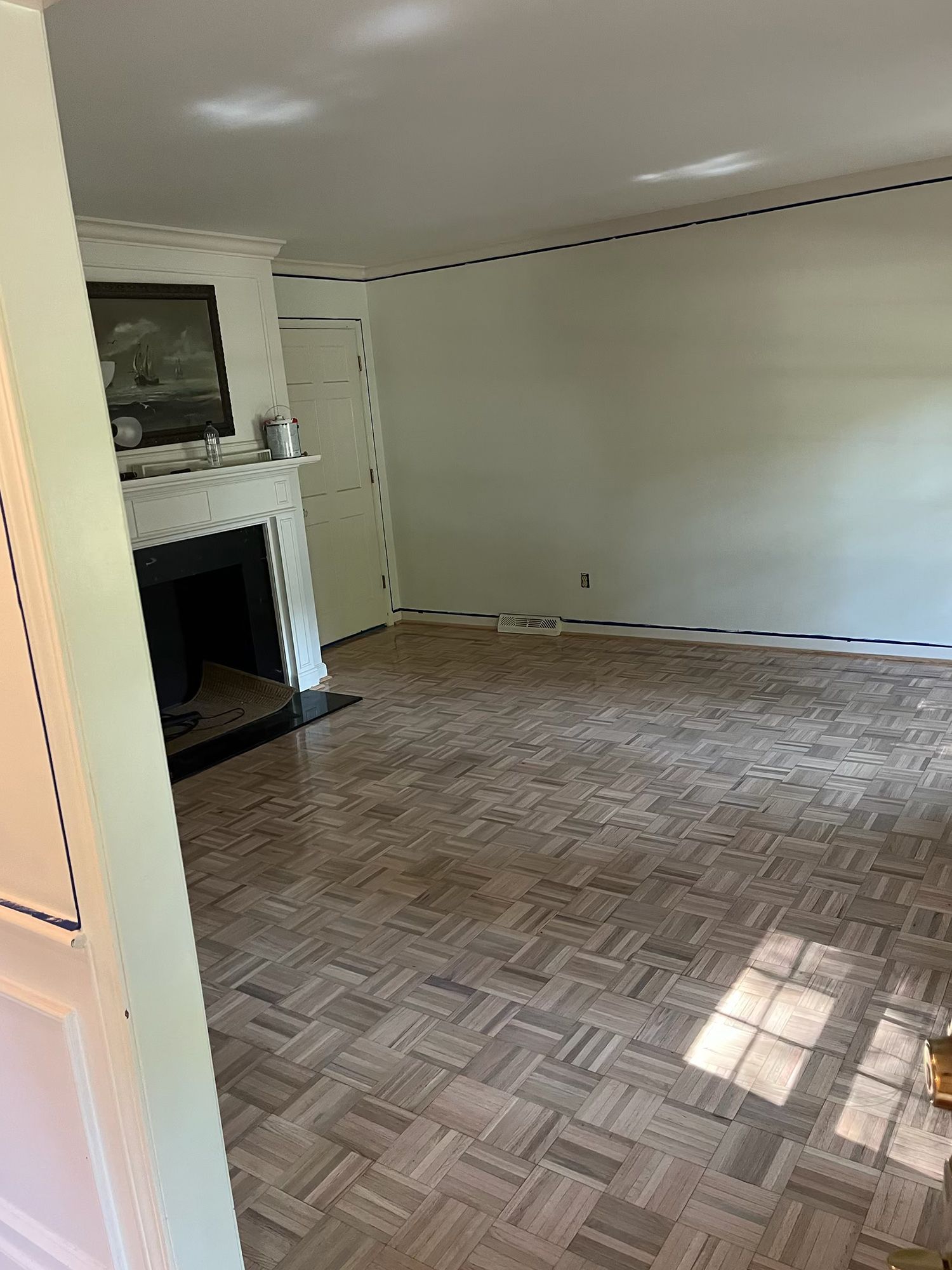 A living room with a fireplace and a wooden floor.