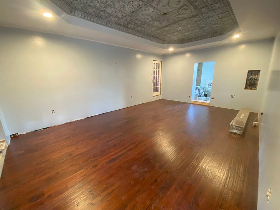 An empty room with newly refinished floor