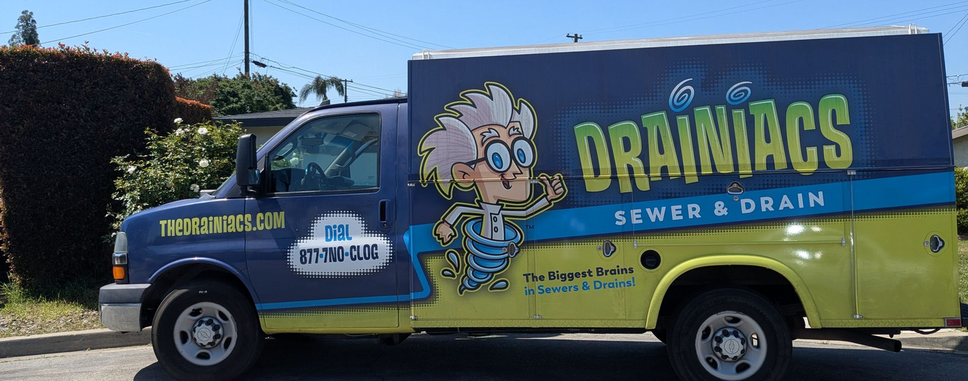Blue work truck with a home in the background. 