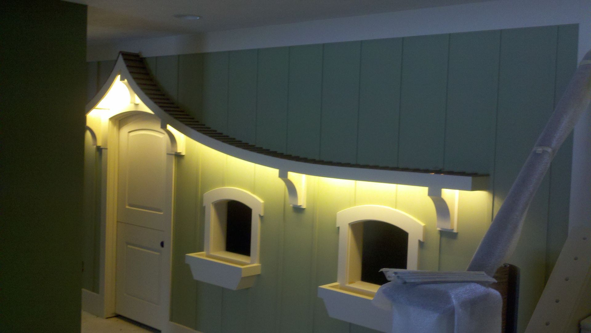 mint-colored wall with white door and windows