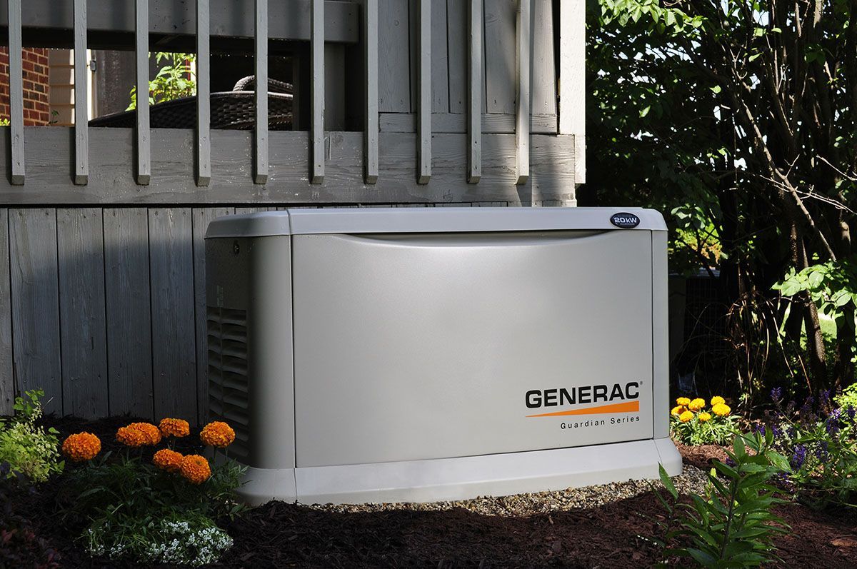A generac generator is sitting outside of a house.