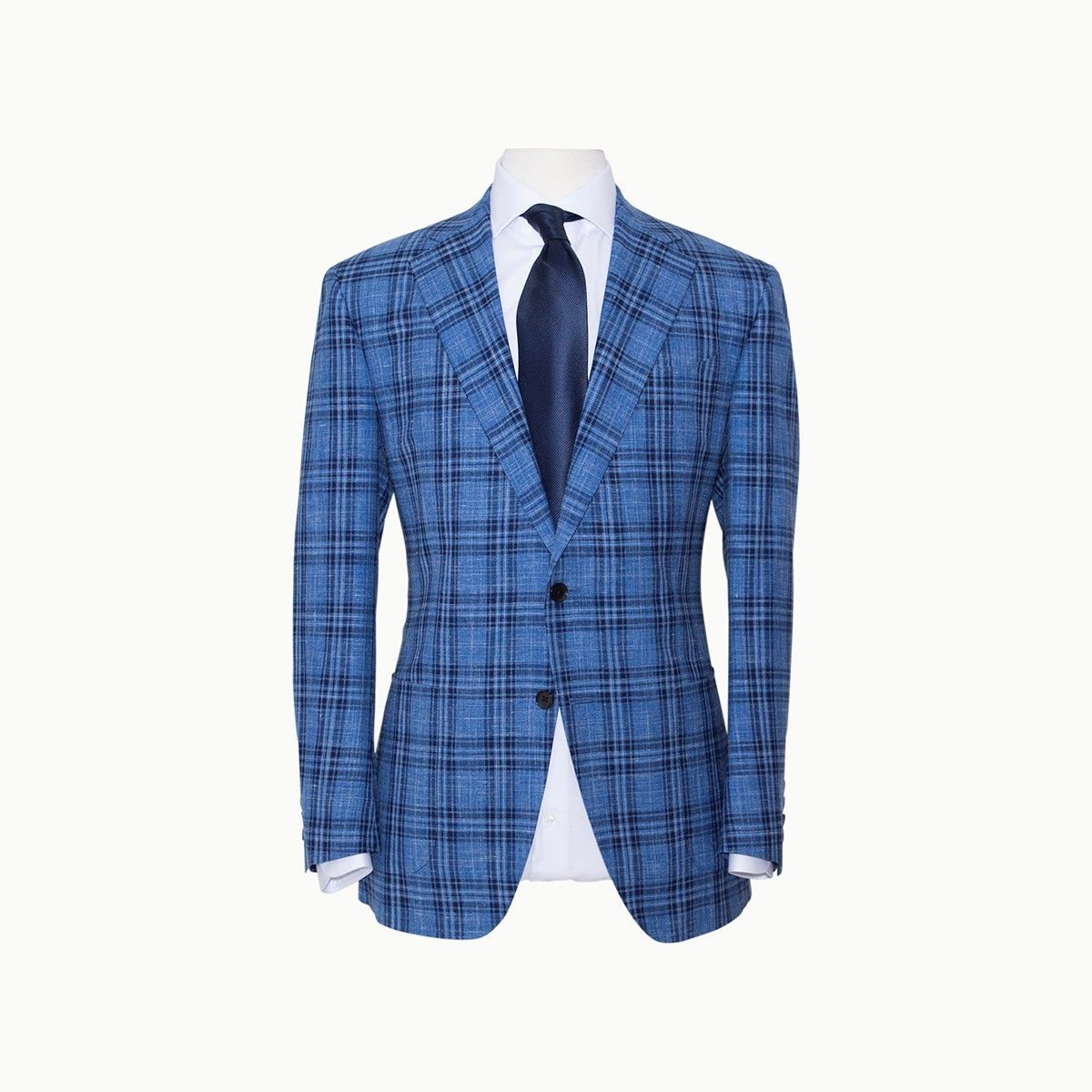 A blue plaid blazer worn with a white shirt and a dark tie on a mannequin.