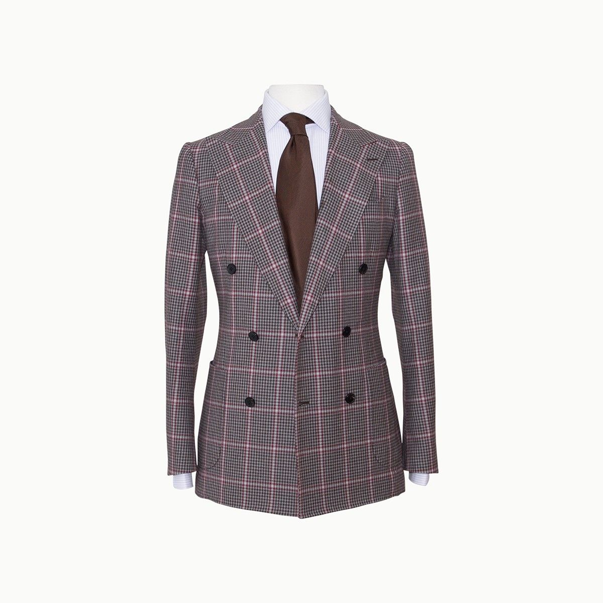 A double-breasted brown plaid suit jacket with a brown necktie on a white shirt.