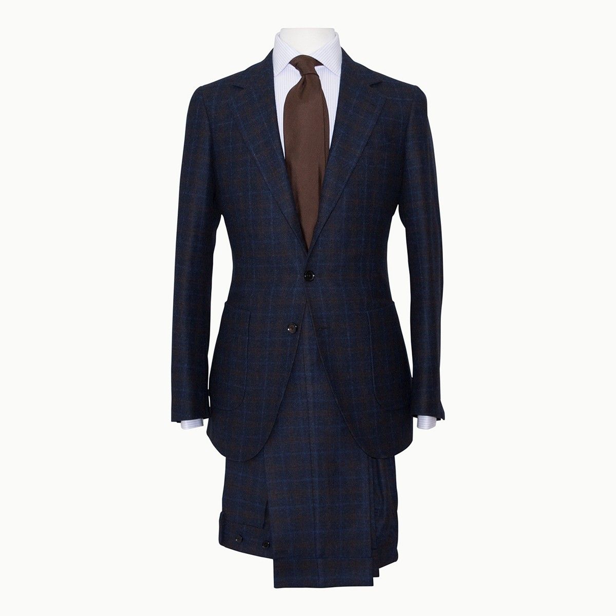 A navy blue, textured suit jacket and matching trousers displayed on a mannequin with a white shirt and brown tie.